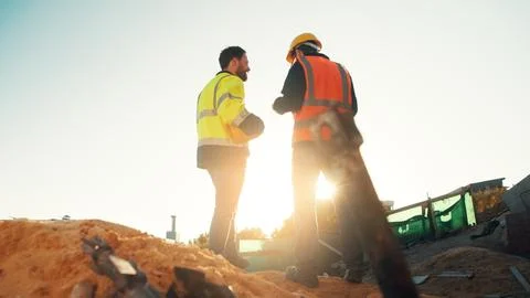 Men, engineer and team talking for construction, building development and Stock Photos