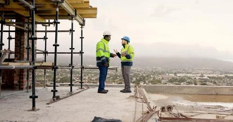 Men, engineer or team on construction site with tablet, maintenance meeting.. Stock Photos