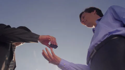 Men exchanging keys and shaking hands Stock Footage 49741893