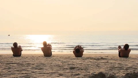 Men exercise on the sand in the morning Video stock 75770926
