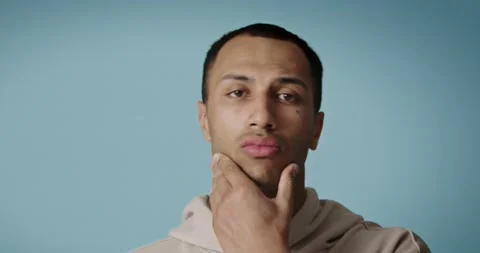 Men face care. Man touching skin after shaving. Serious guy looking camera Stock Footage 221995963
