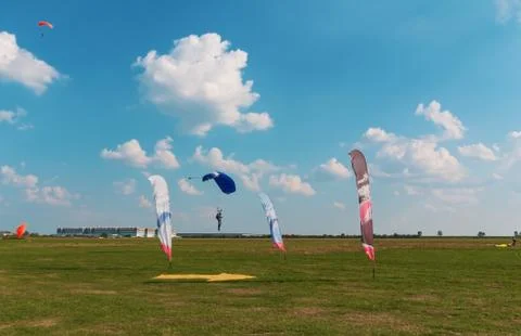 A men flying in the blue sky using parachute Stock Photos