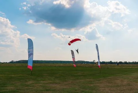 A men flying in the blue sky using parachute Stock Photos