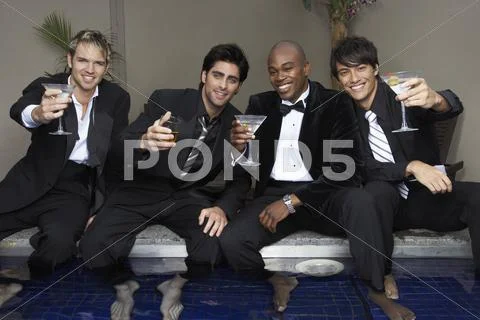 Men In Formal Wear With Feet In Pool Drinking Cocktails