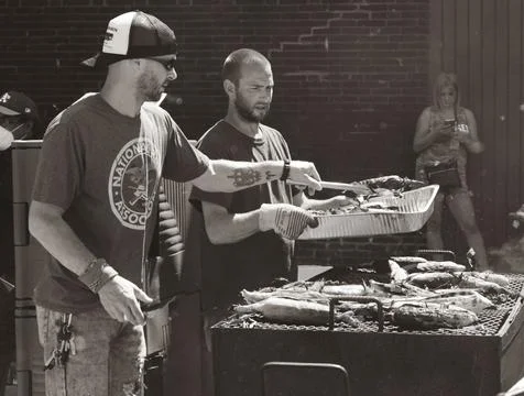 Men grilling corn Stock Photos