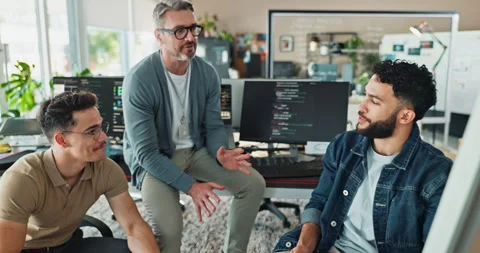Men, group and programming in office with discussion, computer or feedback with Stock Footage 290133817