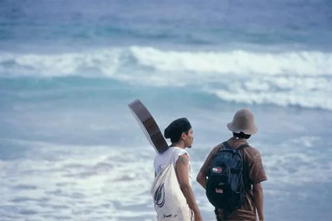 Men with guitars on beach Stock Photos