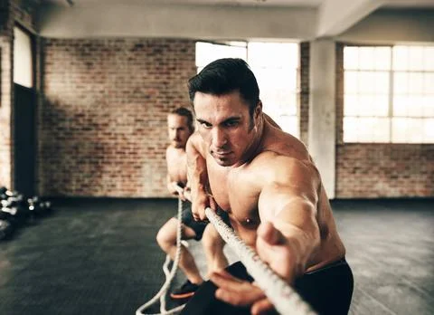 Men, gym and pull rope with training for strong muscle, coaching or teamwork for Stock Photos