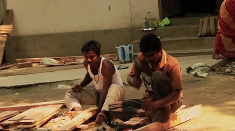 Men hammer doing carpentry in a village in Bengal, India. Stock Footage 39790320