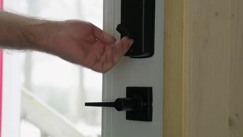 Men hand closed and locked a outside door inside view Stock Footage 258084828