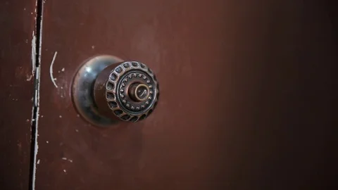 Men hand opens and closes the brass door knobs Stock Footage 78495630