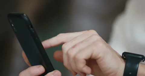 Men hands close-up scrolling the tape of a smartphone Stock Footage 197561147