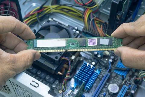 Men hands of Computer technician Cleaning the RAM of the computer. Stock Photos