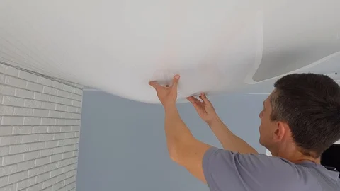 Men is hands hold a bubble from a stretch ceiling. Stock Footage 128292797