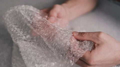 Men hands playing with plastic  bubble wrap. Stock Footage 149595330