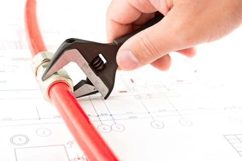 Men hands with spanner connect a pipe Stock Photos