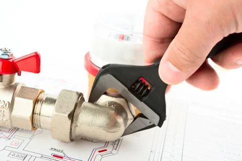 Men hands with spanner installing a counter Stock Photos