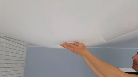 Men hands touch a bubble from a stretch ceiling. Stock-Footage 128292751