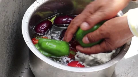 Men hands washing vegetables under tap Stock Footage 154162040