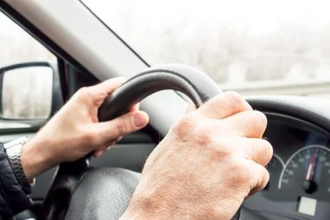 Men hands on the wheel Stock-Fotos