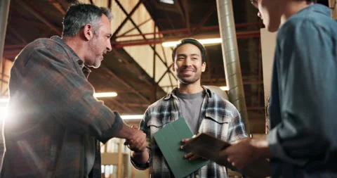 Men, handshake and carpenter group in warehouse with support, tech or happy for Stock Footage 338397539