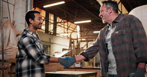 Men, handshake and carpenter team with clipboard for deal, gloves and happy for Stock Footage 338396731