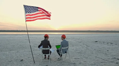 Men in helmets sit on chairs. Stockbeeldmateriaal 137948544