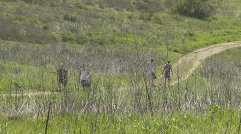 Men Hiking on Hillside Trail Stock Footage 34573698