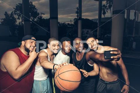 Men Holding Basketball Using Smartphone To Take Selfie