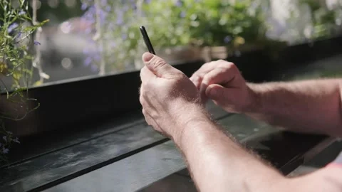 Men holding cell phone using smartphone device in a street cafe. Man blogger Stock-Footage 218610964