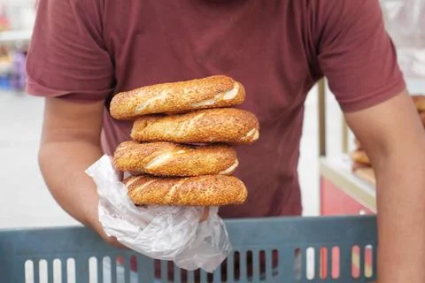 Men holding stack of Turkish Bagel Simit Stock Photos