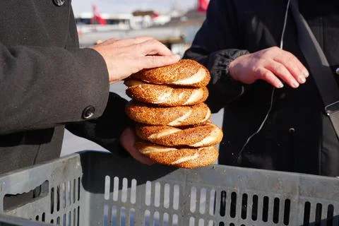 Men holding stack of Turkish Bagel Simit Stock Photos