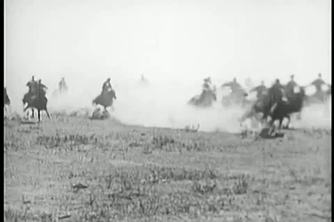 Men on horseback galloping through prairie Stock Footage 11351149
