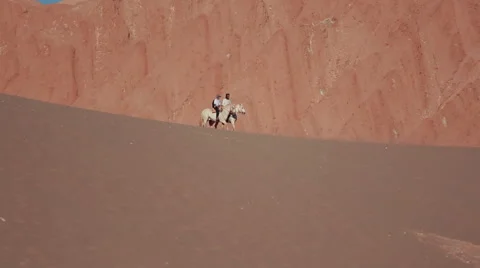 Men on horsebacks in the desert, Nazca Stock Footage 64874059