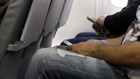 Men inside of aircraft using mobile phones 動画素材 151724306