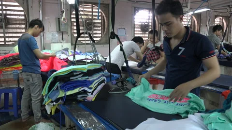 Men ironing shirts, production process, garment factory, export, Vietnam, Asia Stock Footage 61023391
