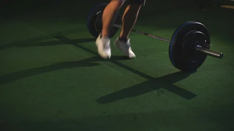 Men jumping over barbells during burpees exercise Stock Footage 91152831