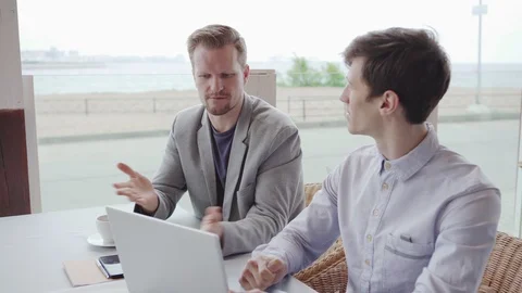 Men with laptop planning project in cafe Stock Footage 111758085