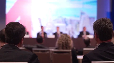 Men learn from a panel at a conference Stock Footage 62415613