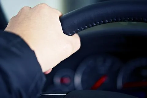 Men left hand on car steering wheel Stock Photos