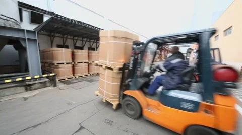 Men on loader machines move boxes near warehouse Stock-Footage 32153003