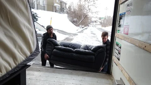 Men loading up a couch into a moving truck Stock Footage 147053503