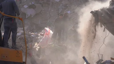 Men look at the removal of rubble after the earthquake Stock Footage 233919656