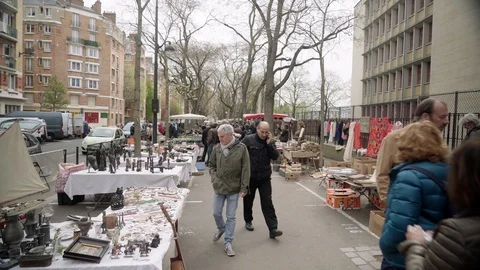 Men Looking At Guitar at Busy Flea Market Portes De Vanves Paris Stock Footage 107700396