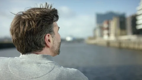 Men is looking over a river and is thinking about his future Stock Footage 97848885