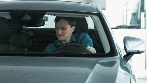Men ls looking new car inside. Stock Footage 93027057