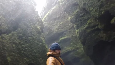 Men in lush waterfall storm circular Stock Footage 124146564