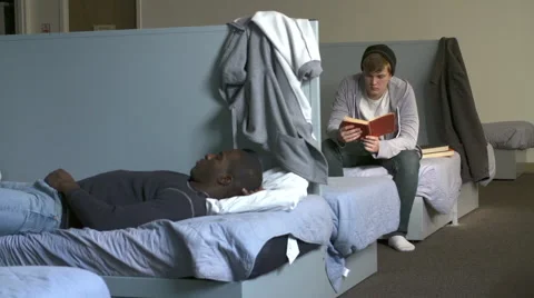 Men Lying On Beds In Homeless Shelter Stock Footage