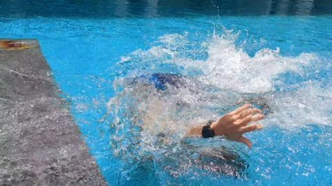 Men make somersault in pool. Splashes of water making circle. Stock Footage 255592139