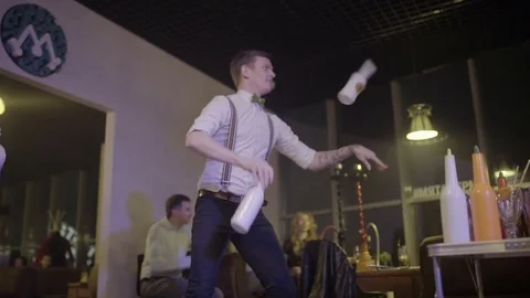 Men makes a show with bottles close-up Stock Footage 76554631